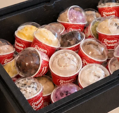 Close-up of pre-scooped gelato cups in assorted flavors, ready to serve