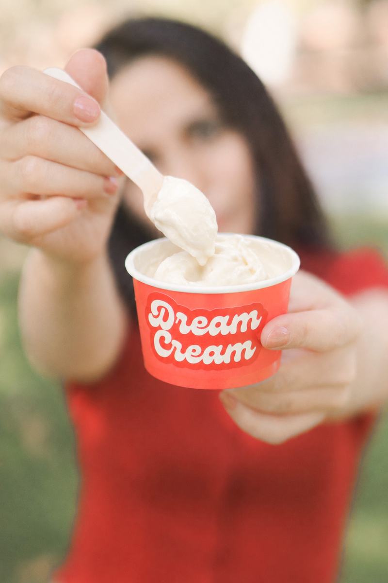Guest holding a scoop of gelato in a Dream Cream cup